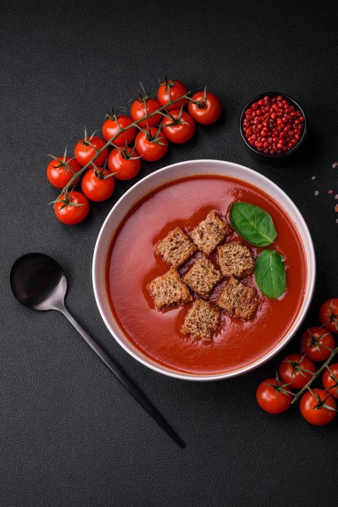 Delicious fresh gazpacho with breadcrumbs, salt and spices in a ceramic plate