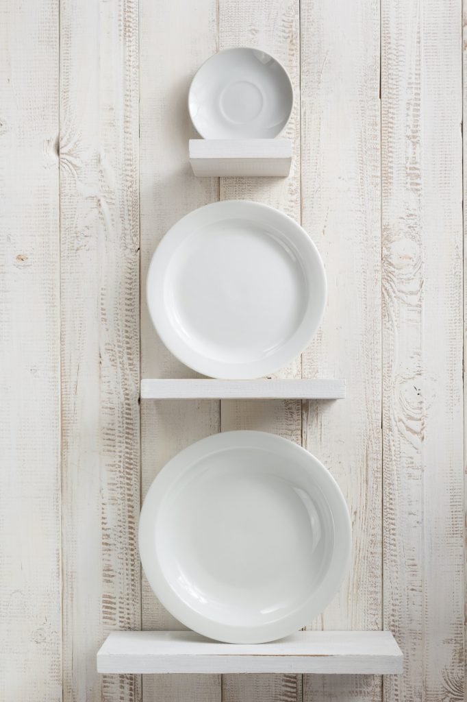 plate at kitchen shelf on wooden background